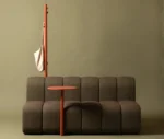 Bla Station BOB Café modular sofa in studi setting with integrated side table and hanger in front view.
