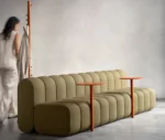 Close-up of Bla Station BOB Café modular sofa in studio setting with integrated side table and hanger in side view.