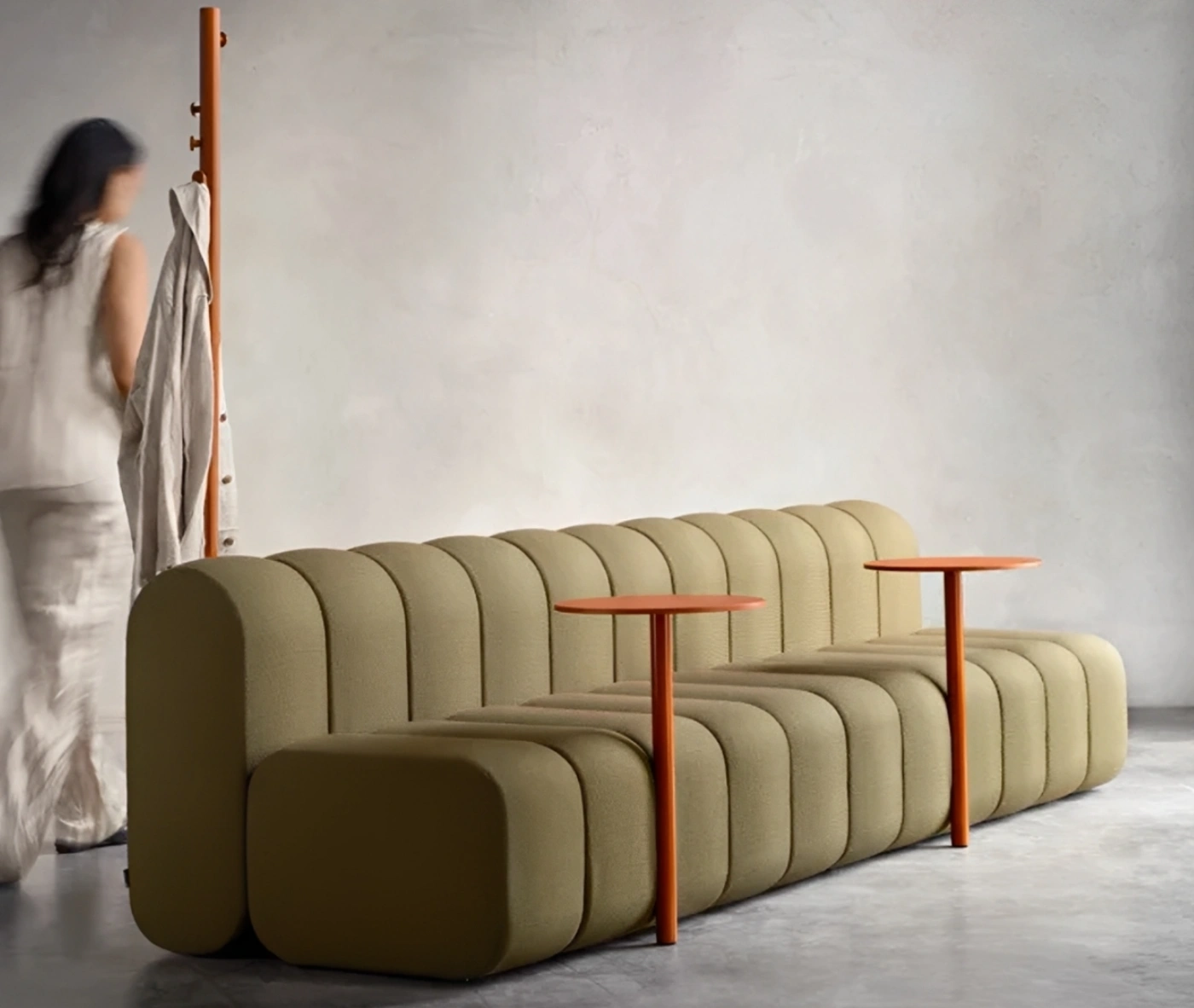 Close-up of Bla Station BOB Café modular sofa in studio setting with integrated side table and hanger in side view.