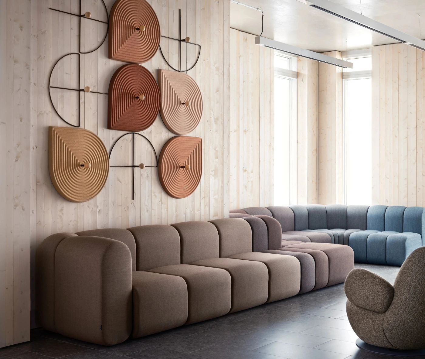 Bla Station Decofunc acoustic wall panel in side view, mounted on a wall in a lounge setting.