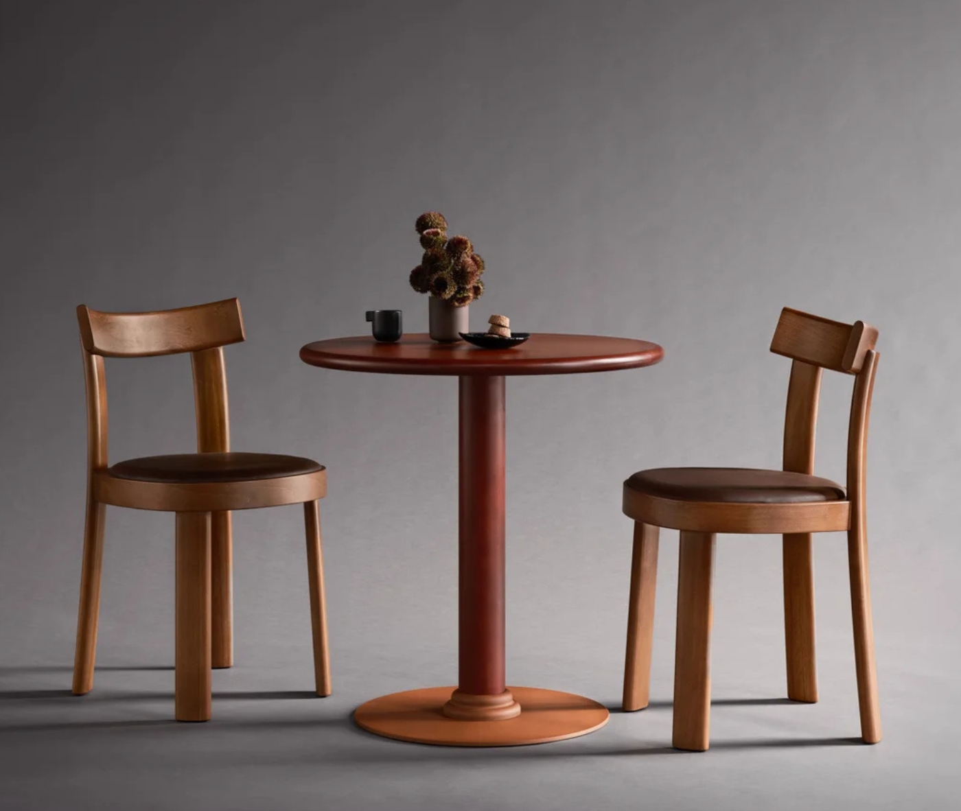 Bla Station Frankfurter table and chairs featuring dark brown timber finishes in a studio setting.