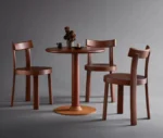 Bla Station Bla Station Frankfurter table and chairs featuring dark brown timber finishes in a studio setting.