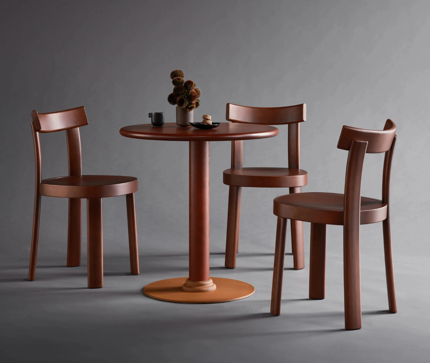 Bla Station Bla Station Frankfurter table and chairs featuring dark brown timber finishes in a studio setting.