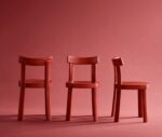 Bla Station Frankfurter chairs lined up in red timber in a studio setting.