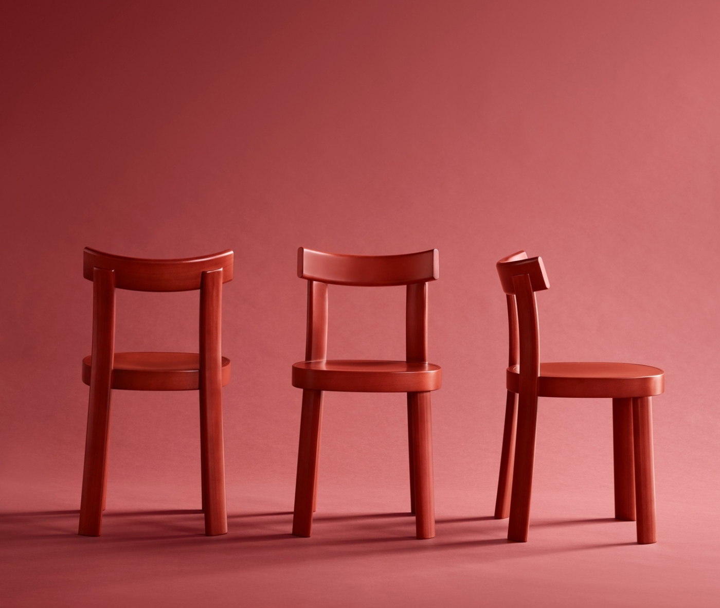 Bla Station Frankfurter chairs lined up in red timber in a studio setting.