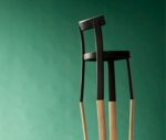 Bla Station Frankfurter chair with a black timber frame and natural timber legs in a studio setting.