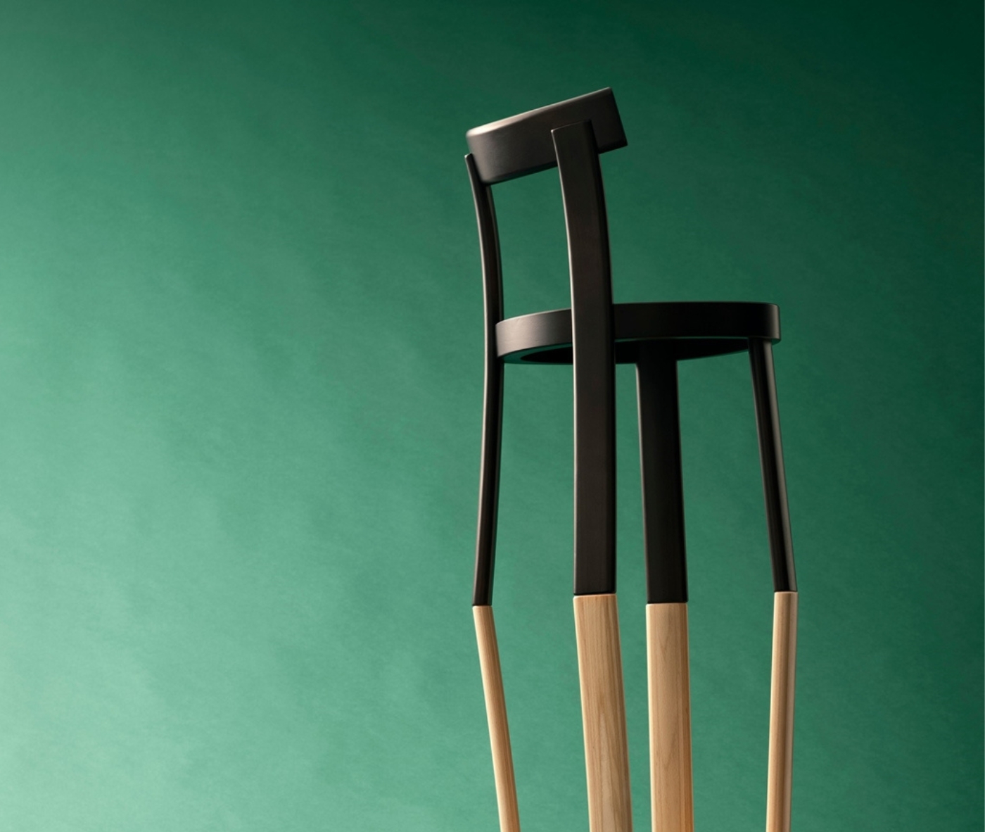 Bla Station Frankfurter chair with a black timber frame and natural timber legs in a studio setting.