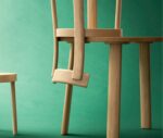 Bla Station Frankfurter chair hooked onto a matching timber table in a studio setting.