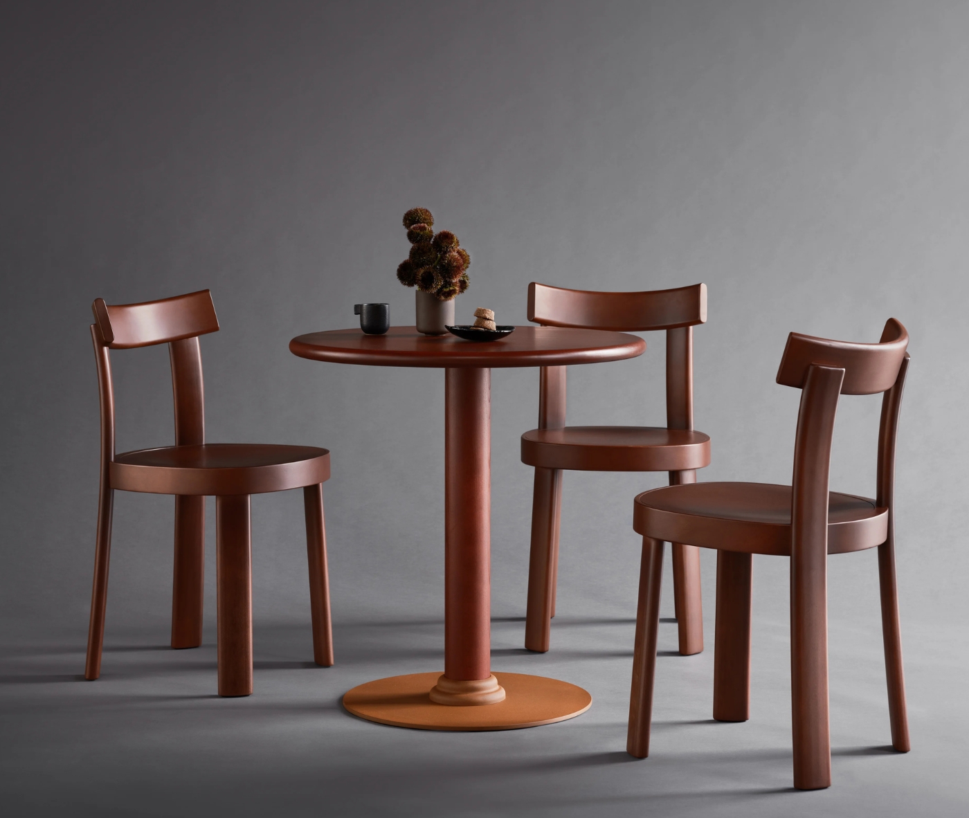 Bla Station Frankfurter table and chairs featuring dark brown timber finishes in a studio setting.