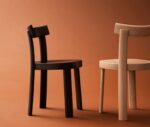Bla Station Frankfurter chairs facing each other, featuring black and natural timber finishes.