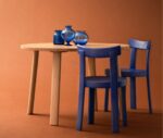 Bla Station Frankfurter blue timber chairs with a natural timber table in a studio setting.