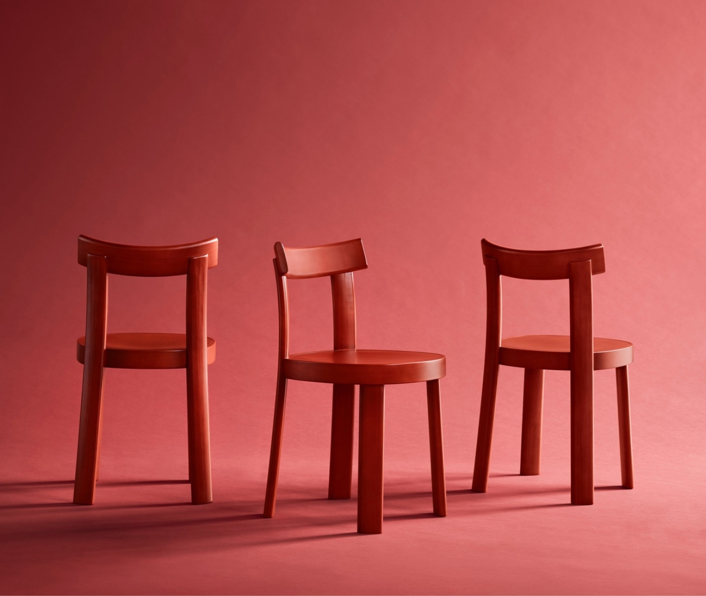 Bla Station Frankfurter red timber chairs with a natural timber table in a studio setting.