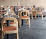Bla Station OM chairs in a hospitality setting with timber frames and upholstered seats and backrests.
