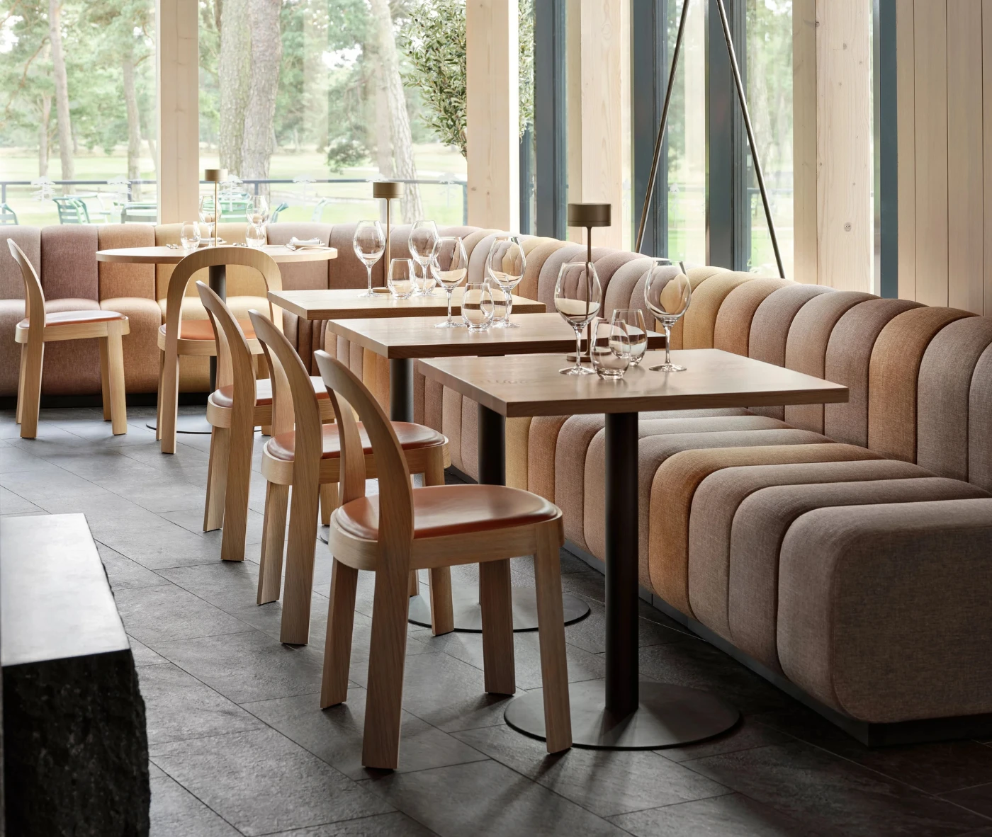 Bla Station BOB sofa and OM chairs in a hospitality setting featuring timber frames and upholstered seats and backrests.