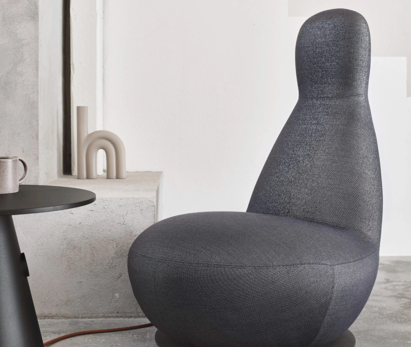 Bla Station Oppo lounge chair with a high rounded back and fully upholstered sculptural design.