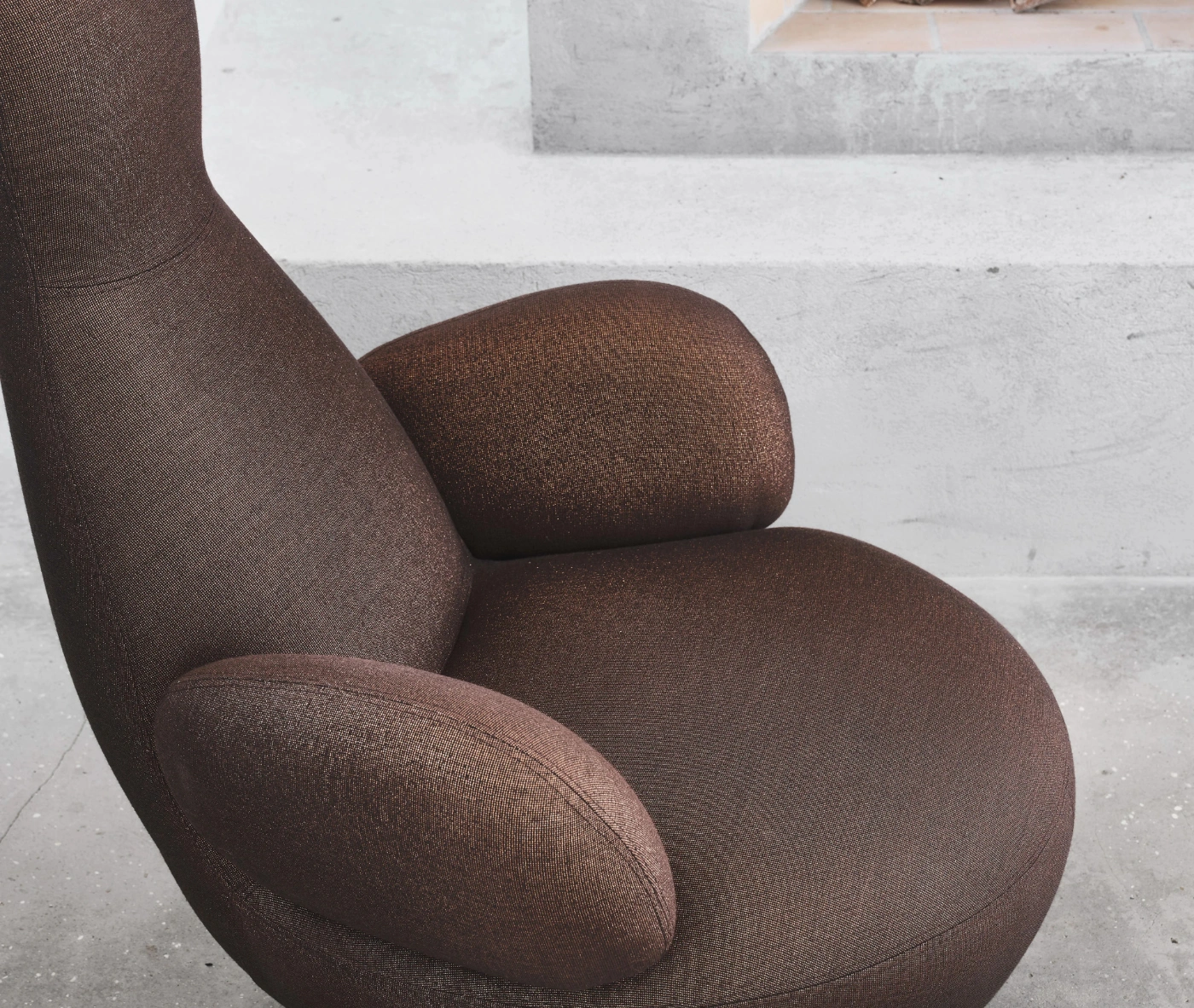 Bla Station Oppo lounge chair with brown upholstery and a sculptural form.
