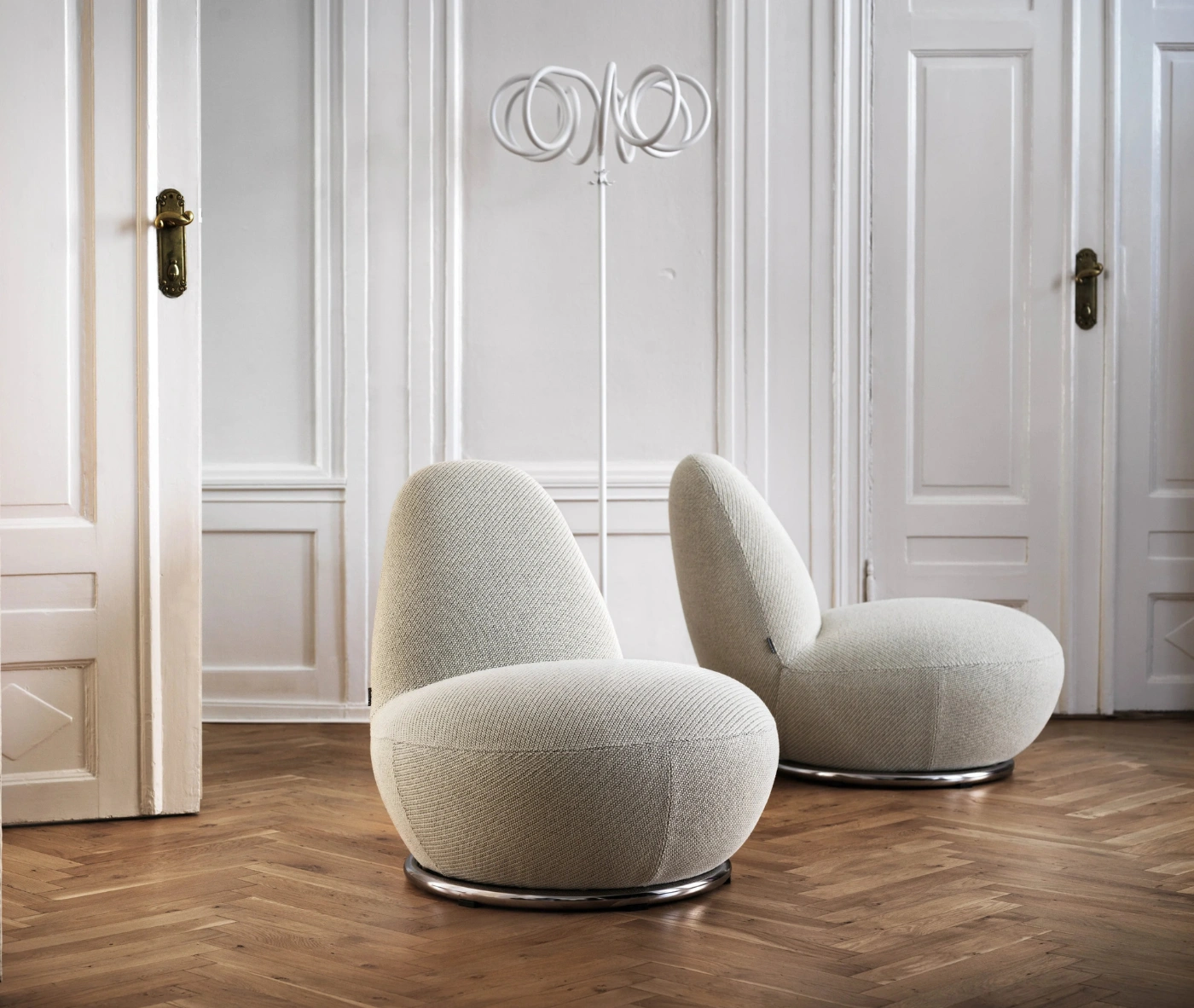 Bla Station Oppo lounge chair with fully upholstered white fabric and a rounded sculptural design.