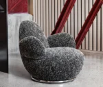 Bla Station Oppo lounge chair in a lounge setting with black-and-white speckled upholstery.