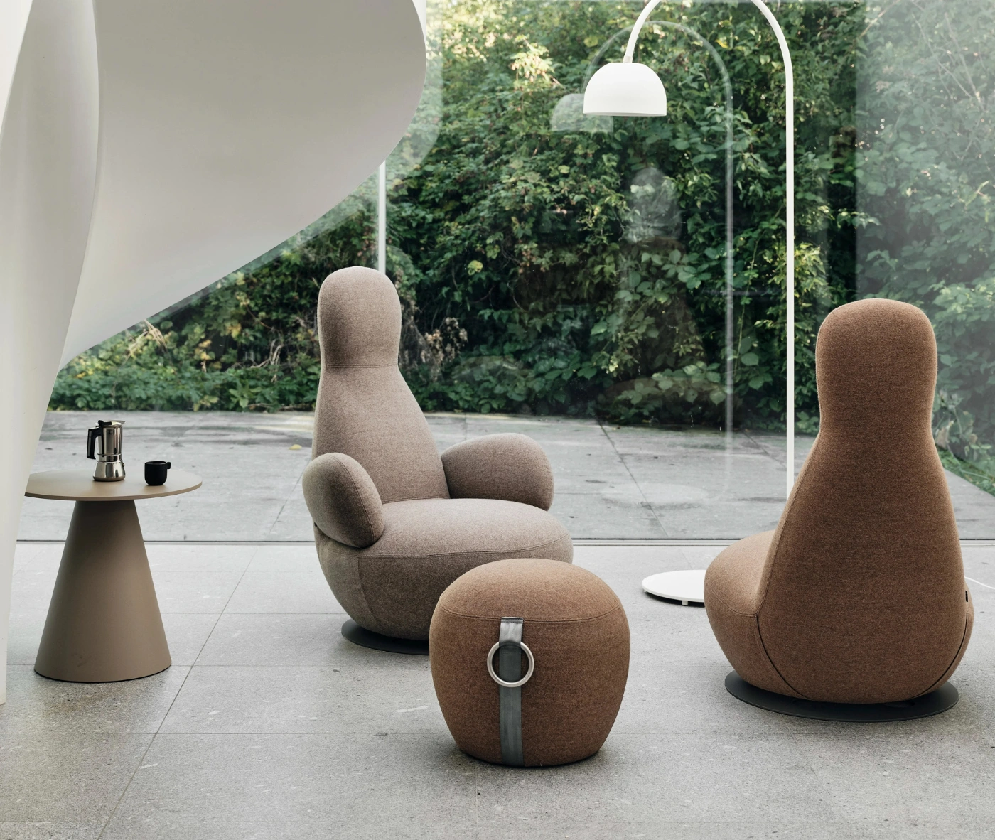 Bla Station Oppo lounge chairs with matching ottoman and Jackless side table in a modern lounge setting.