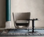 Bla Station Pocket lounge chair with cocoon-like upholstered design and under-seat storage.