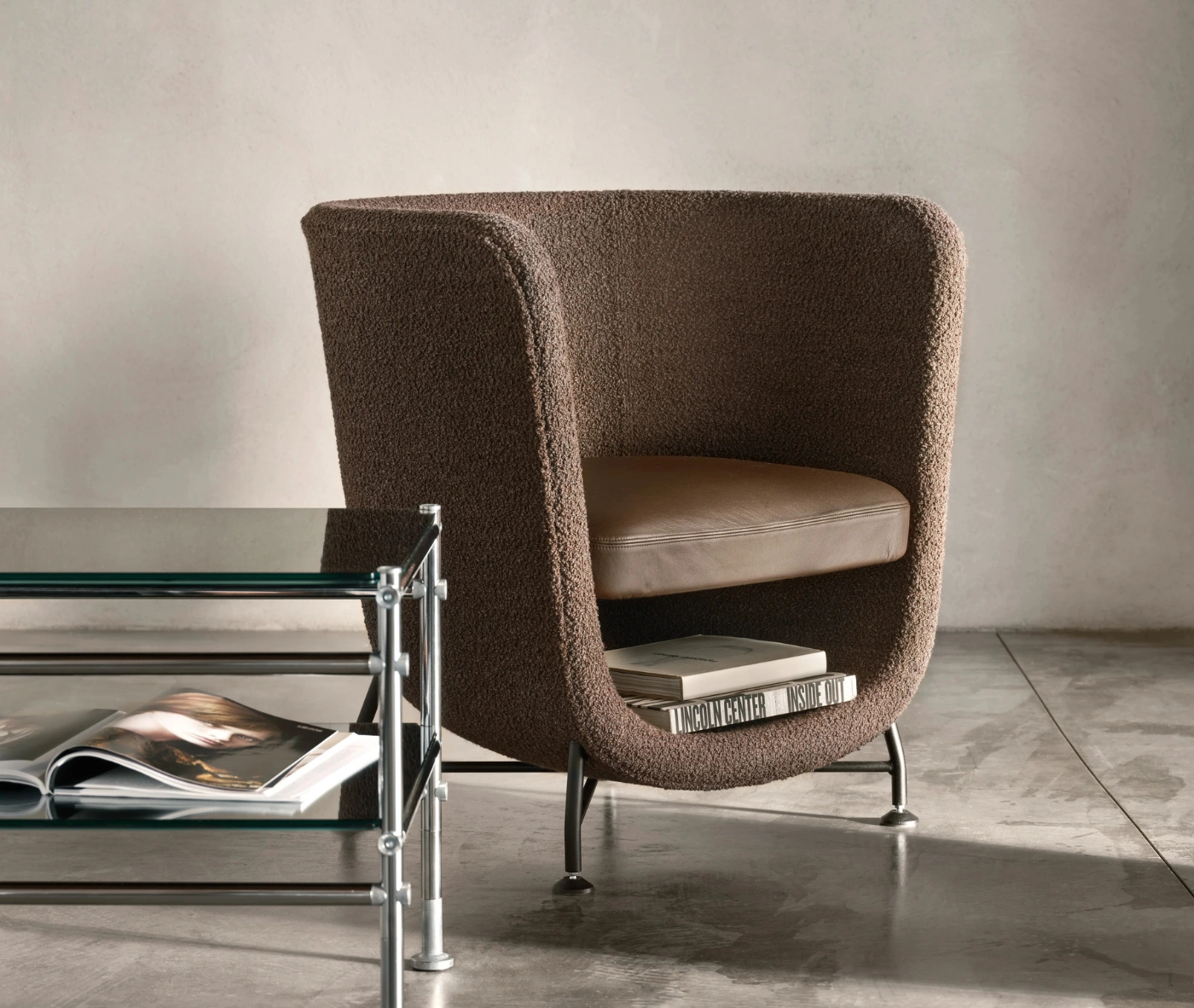 Bla Station Pocket lounge chair with brown cocoon-like upholstered design and under-seat storage.