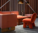Bla Station RUT modular sofa with red upholstery and MAX chair in a lounge setting.