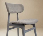 P4 Annalisa C2 hospitality chair in front-right, in studio setting, grey upholstered seat, and timber frame.