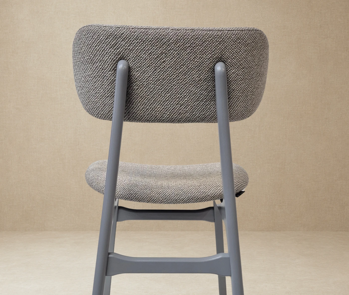 P4 Annalisa C2 hospitality chair in back view, in studio setting, grey upholstered seat, and timber frame.