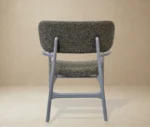 P4 Annalisa L2 lounge chair in back view, studio setting, upholstered seat, timber frame and armrests.