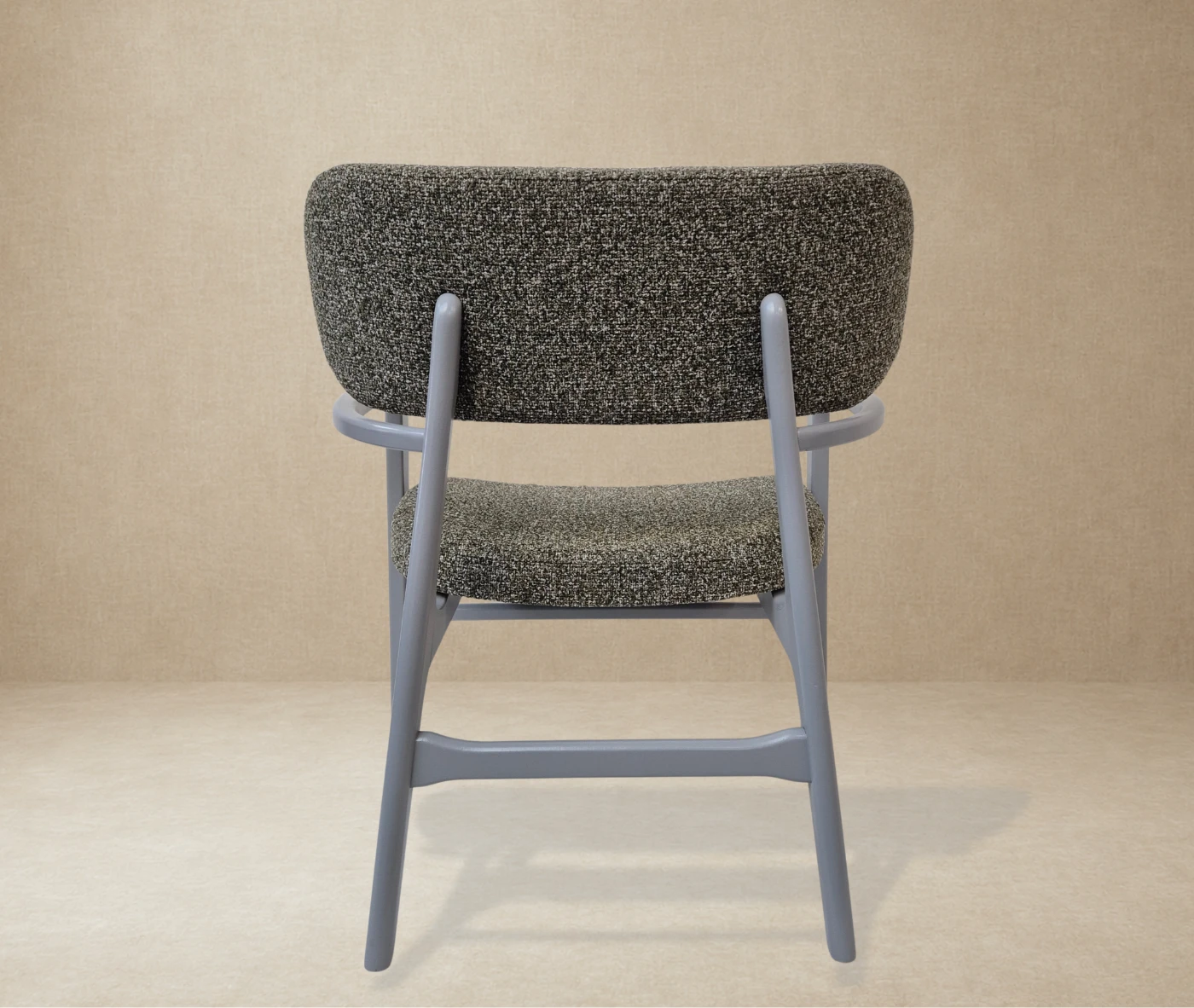 P4 Annalisa L2 lounge chair in back view, studio setting, upholstered seat, timber frame and armrests.