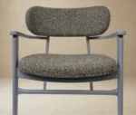 P4 Annalisa L2 lounge chair in studio setting, upholstered seat and backrest, grey timber frame armrests.