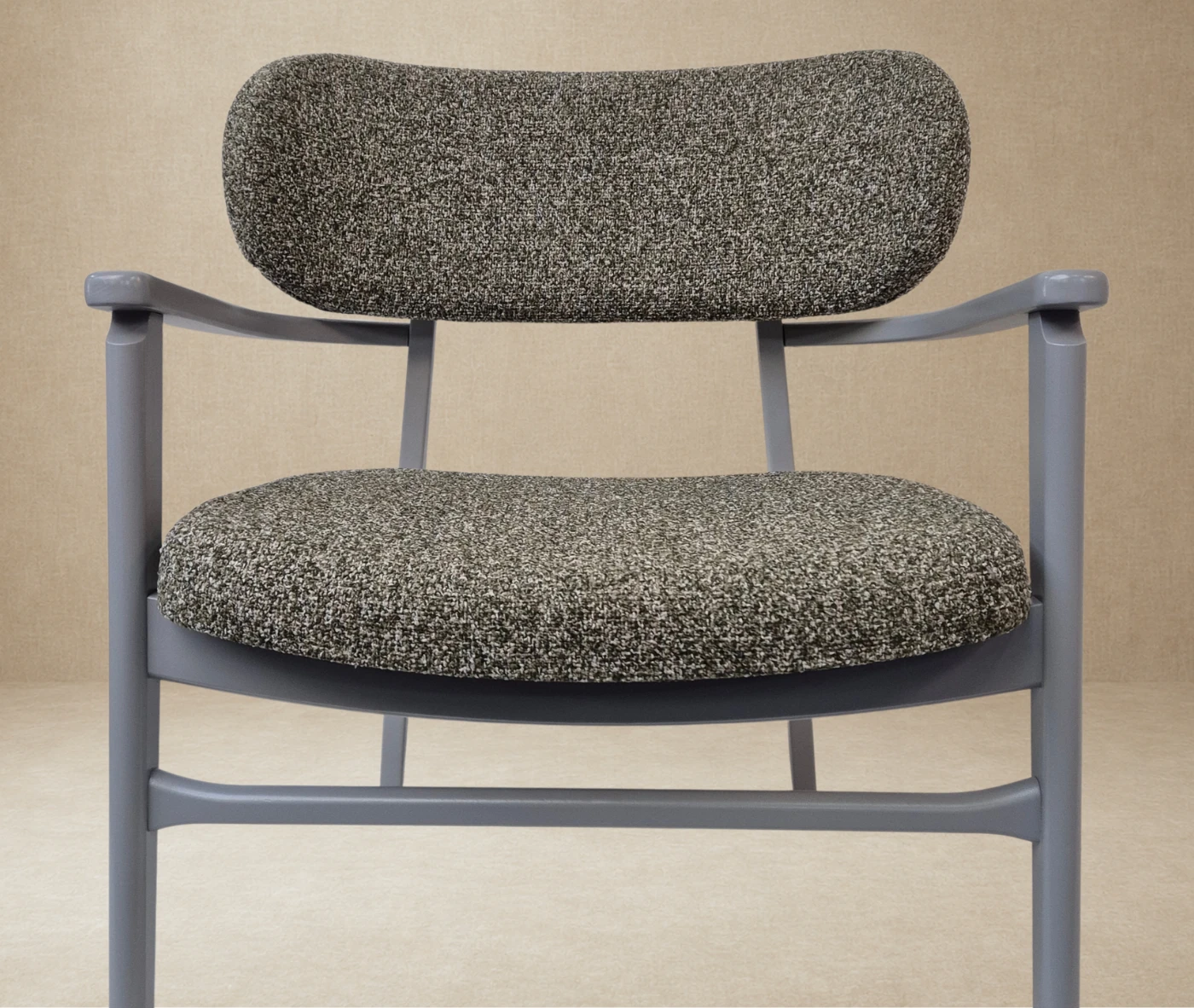 P4 Annalisa L2 lounge chair in studio setting, upholstered seat and backrest, grey timber frame armrests.