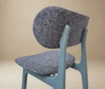 Close-up back-left view of P4 Annalisa S2 stool in studio setting, dark upholstered seat and backrest in timber frame.