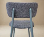 Close-up back view of P4 Annalisa S2 stool in studio setting, dark upholstered seat and backrest in timber frame.