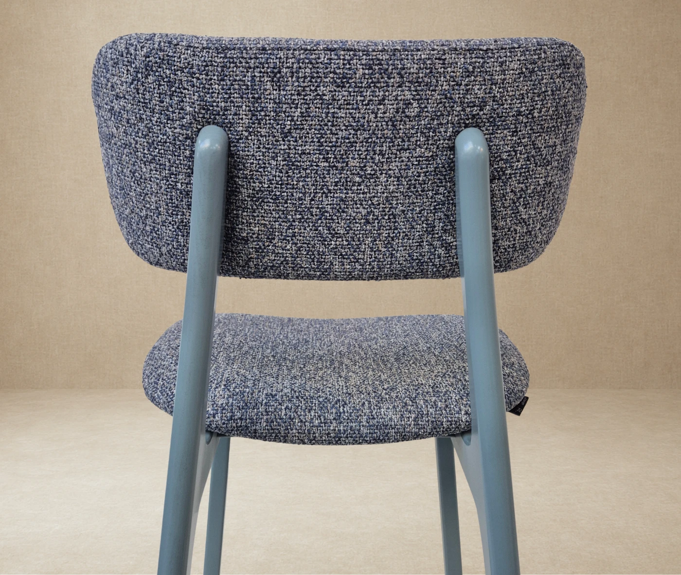 Close-up back view of P4 Annalisa S2 stool in studio setting, dark upholstered seat and backrest in timber frame.