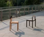 True Adinne chairs in outdoor setting with assorted timber finishes and leather backrests.
