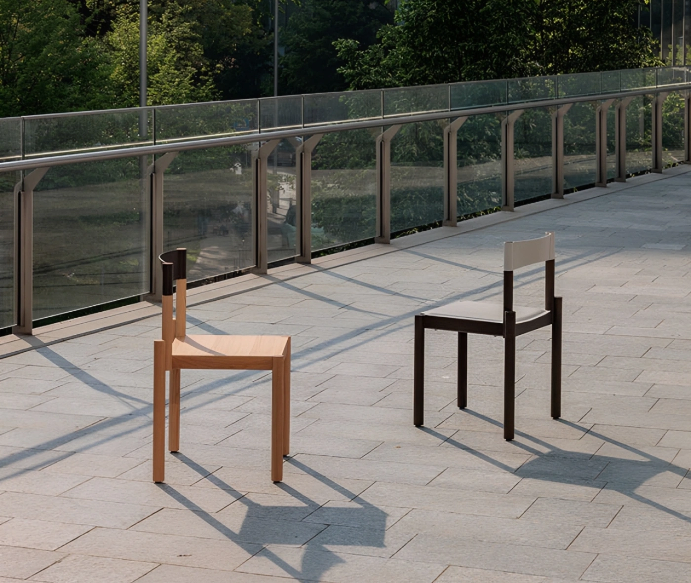 True Adinne chairs in outdoor setting with assorted timber finishes and leather backrests.