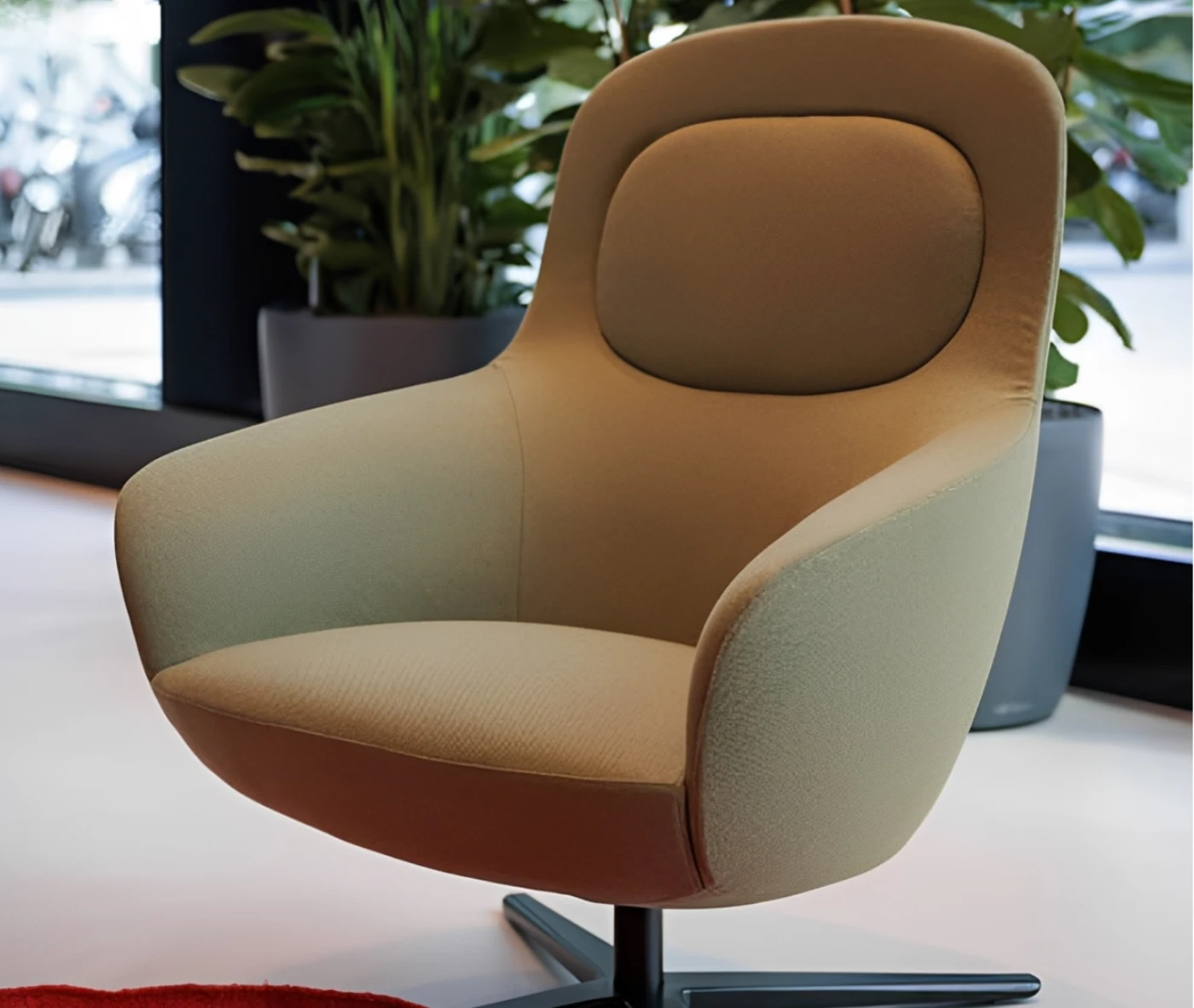 True Ahkka lounge chair in a hospitality setting with soft upholstered curves.