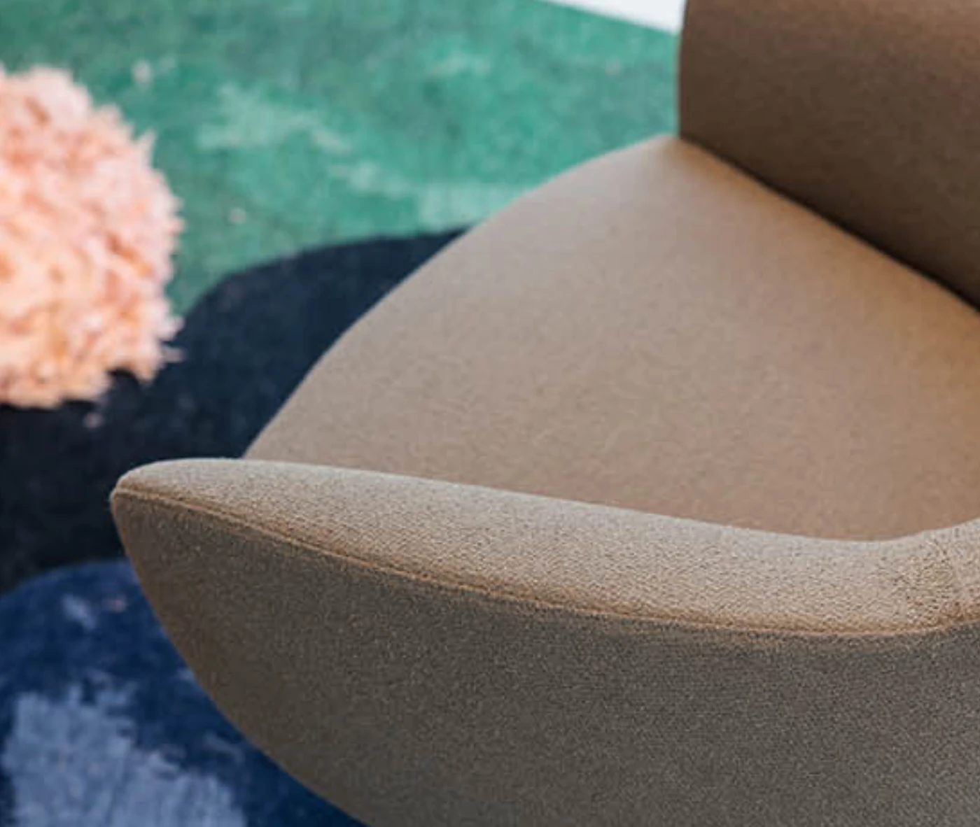 Close-up of True Ahkka lounge chair upholstered chair in beige.