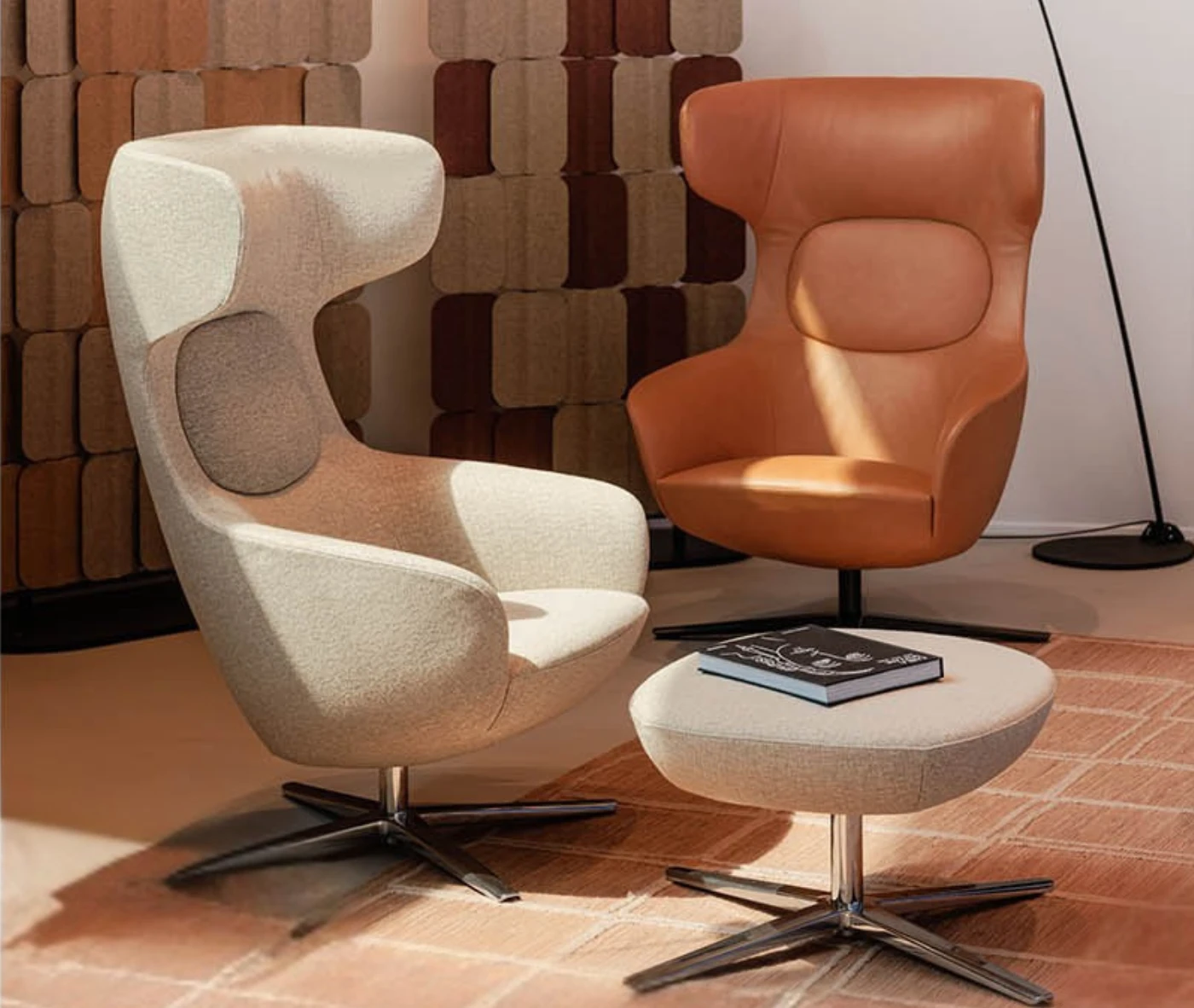 True Ahkka lounge chairs and ottoman in lounge setting with sculpted upholstery and swivel bases.