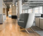 True Arca high-back lounge chair in an office setting with high grey upholstered backrest, seat pad, and timber legs.