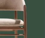 True Aura lounge chair in studio setting with upholstered seat and backrest.