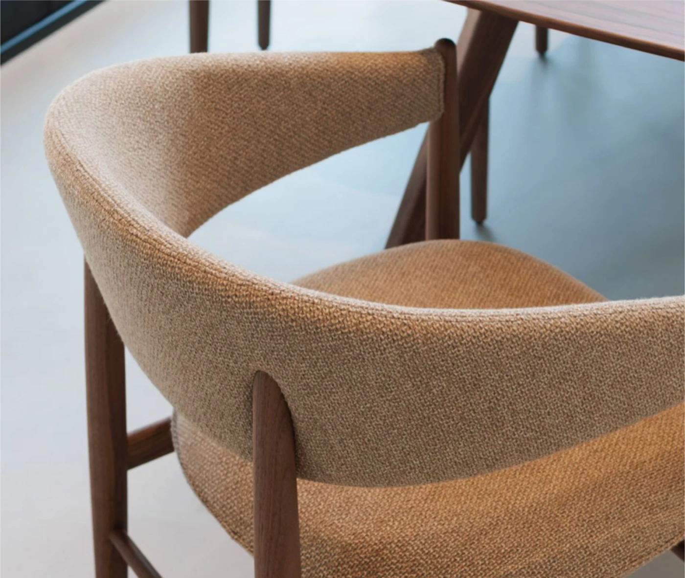 Close-up of True Aura in meeting setting with curved upholstered backrest and seat.