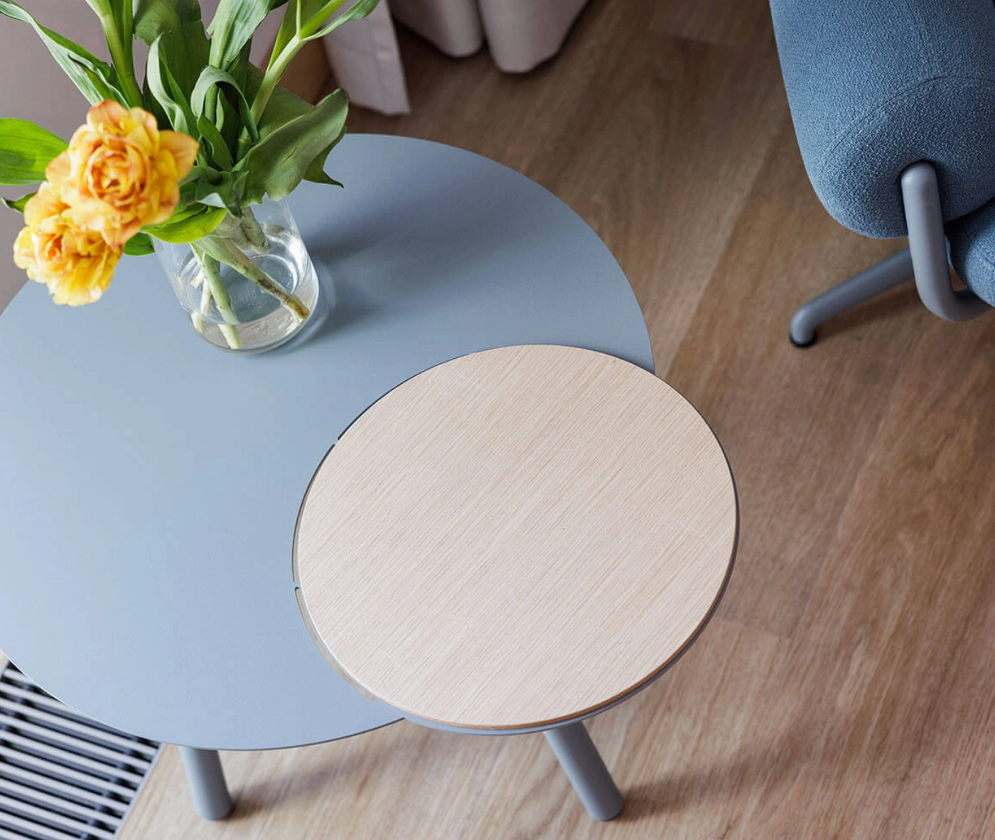 True Cloud occasional table shown from above with blue and timber round tops in a styled lounge setting.