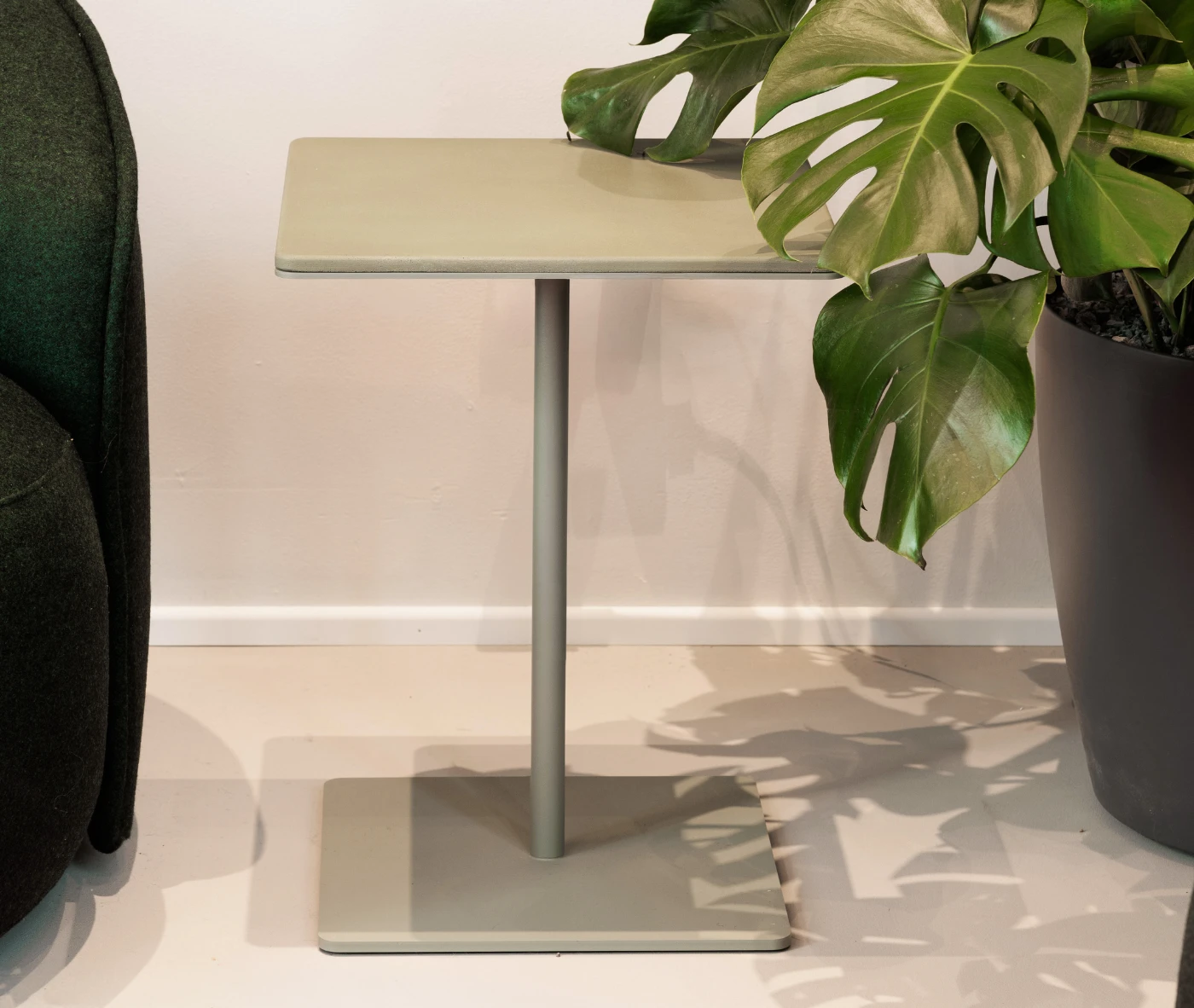 True Cremino table in showroom setting with rectangular top and metal base.