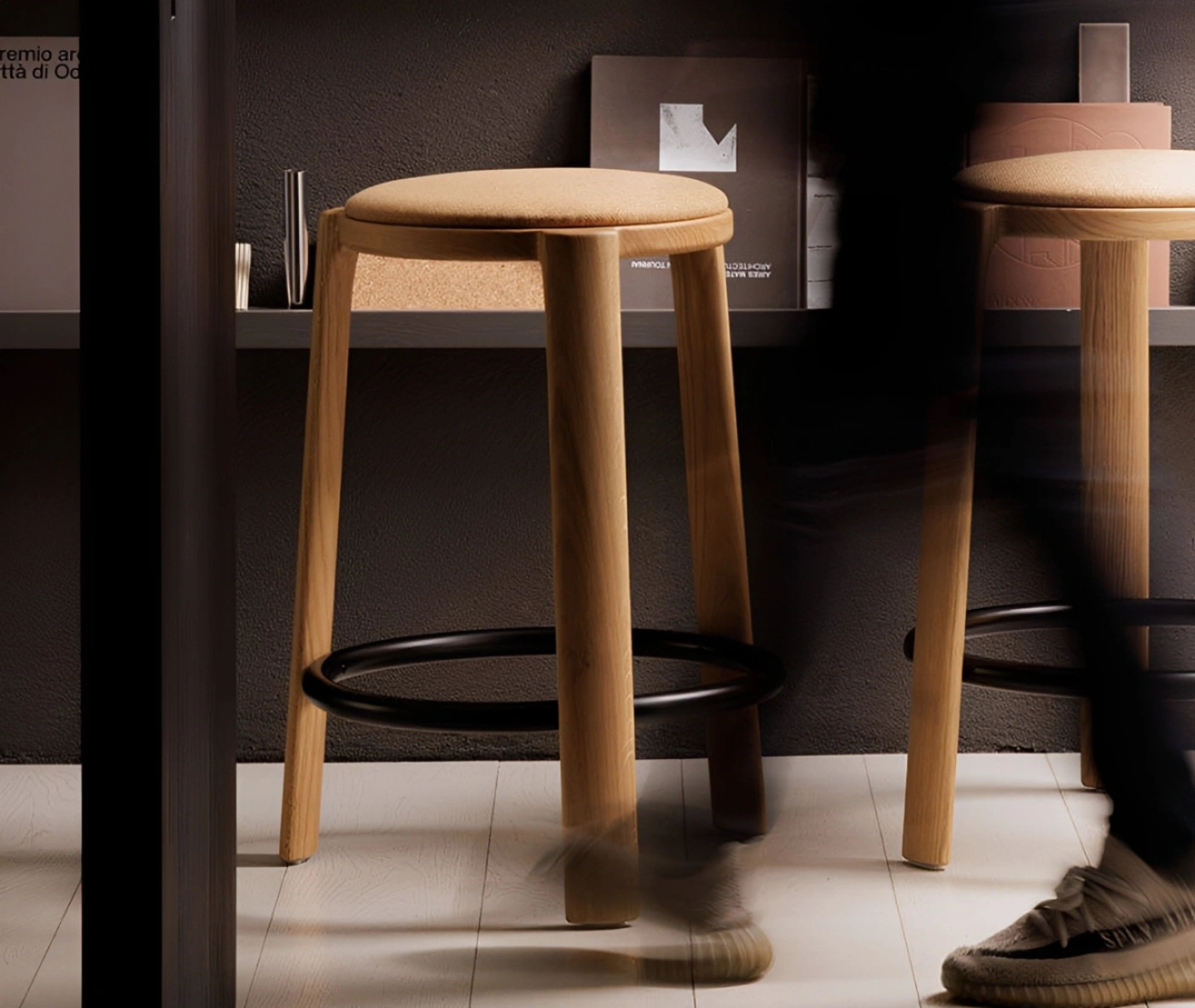 True Cute stools with upholstered seat, timber legs, circular footrest in a library setting.