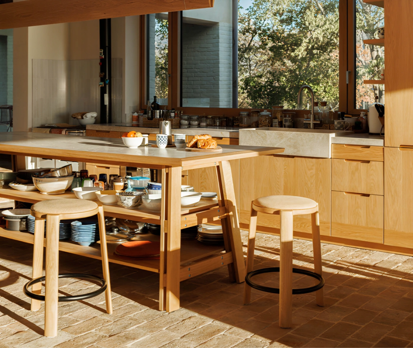 True Cute stools with upholstered seat, timber legs, circular footrest in a kitchen setting.