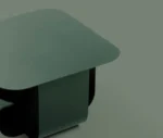 True Fiocco table close-up in studio setting with soft-edged square top and short curved metal base.