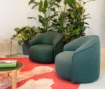 True Sibillino lounge chairs in a showroom setting with rounded upholstered forms.