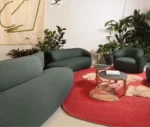 True Sibillino sofa and lounge chair paired with Cute and Cremino tables in a showroom setting.